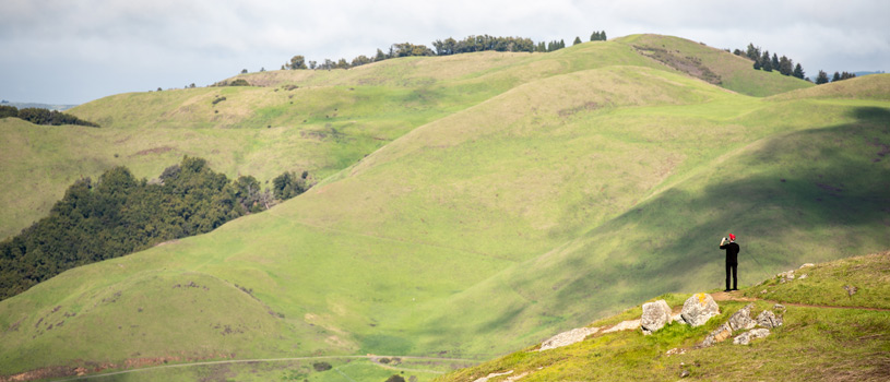 Hiker with green hills in the backgground