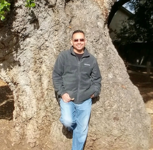 Richard Tejeda leaning on a tree